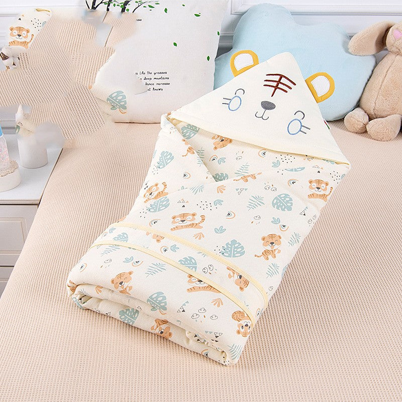 Folded baby blanket with animal patterns on a bed